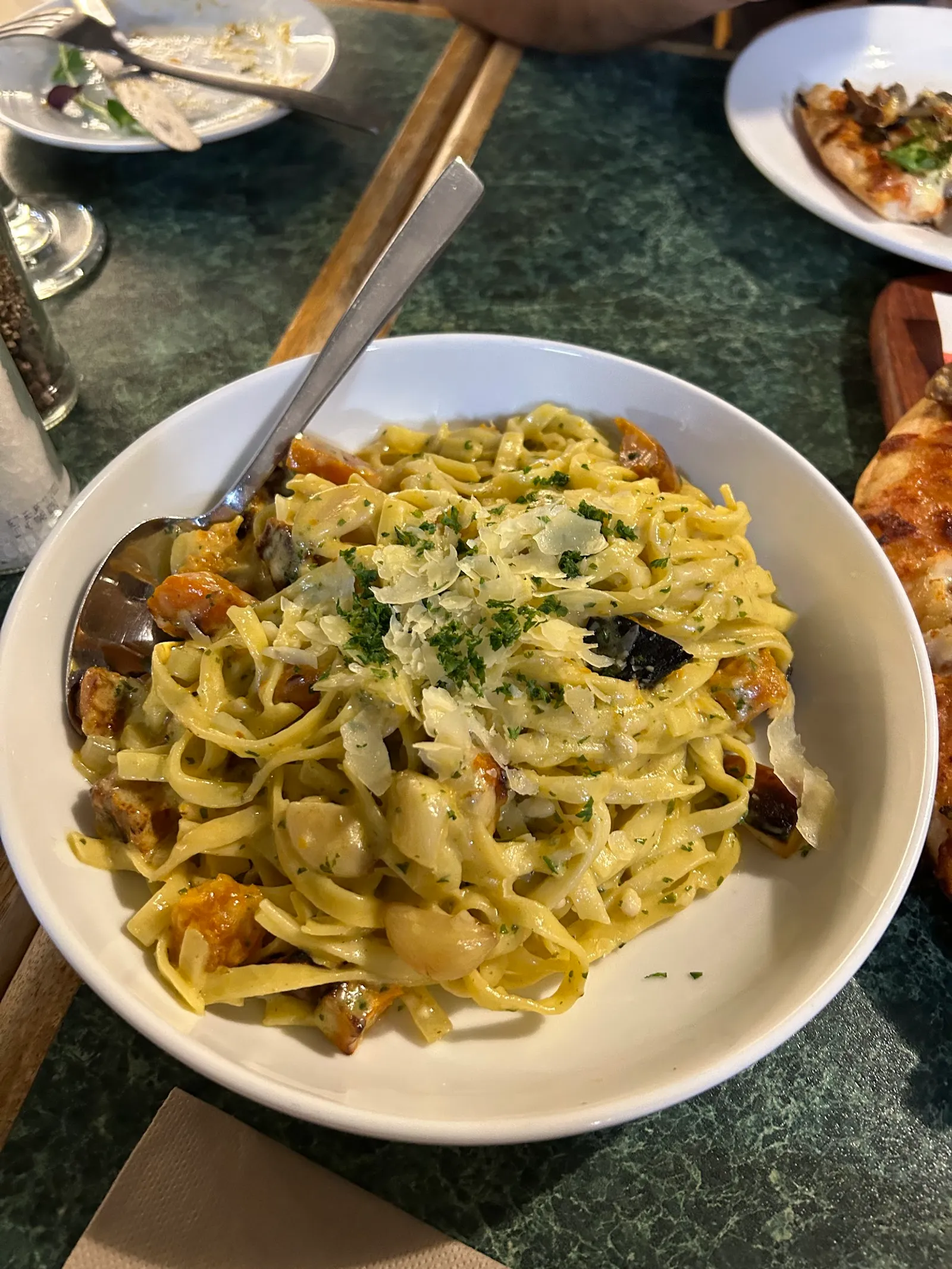 Bowl of creamy fettuccine with mushrooms, chicken and shaved parmesan